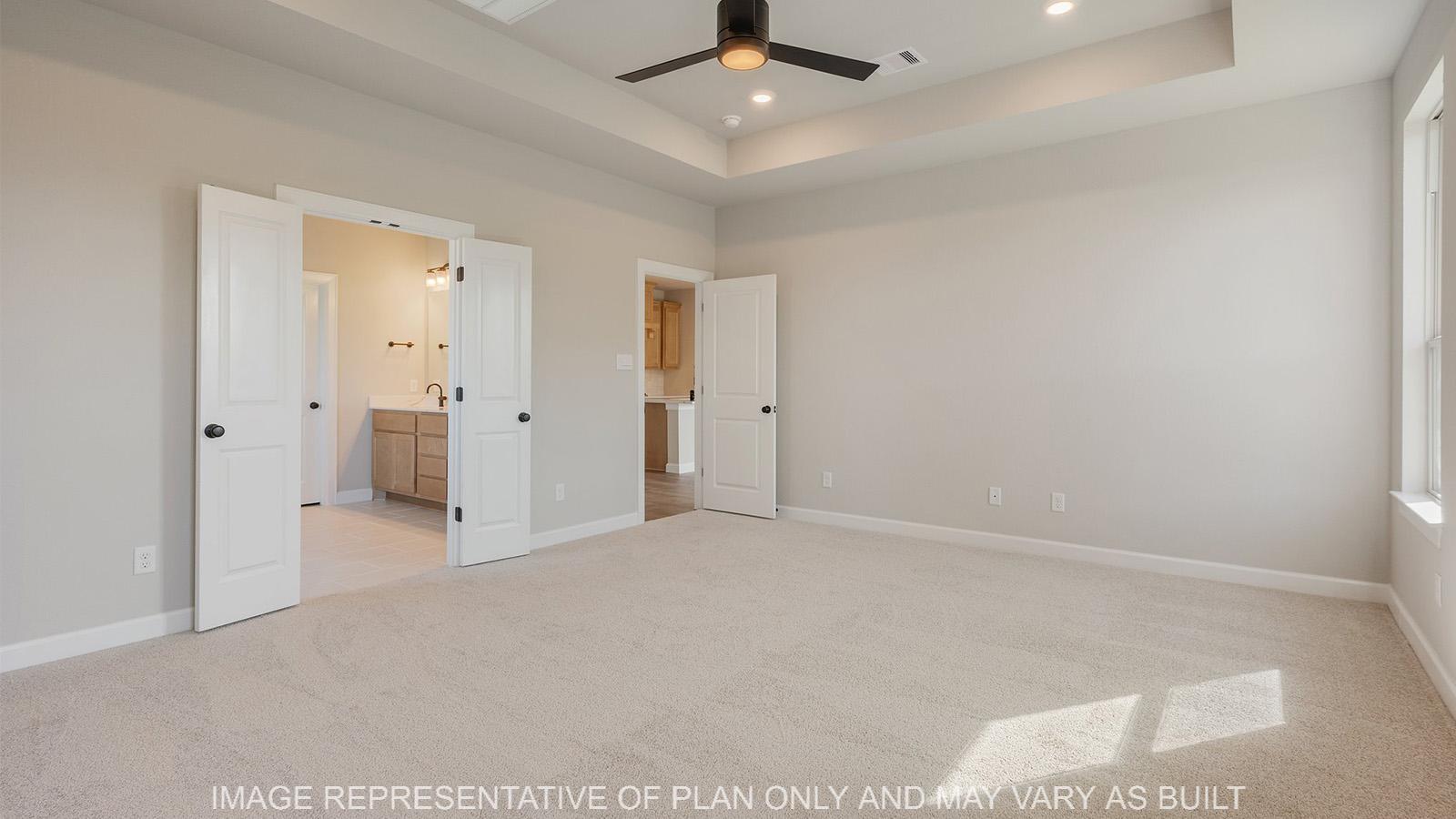 Norwood primary bedroom with ceiling fan and bathroom access.