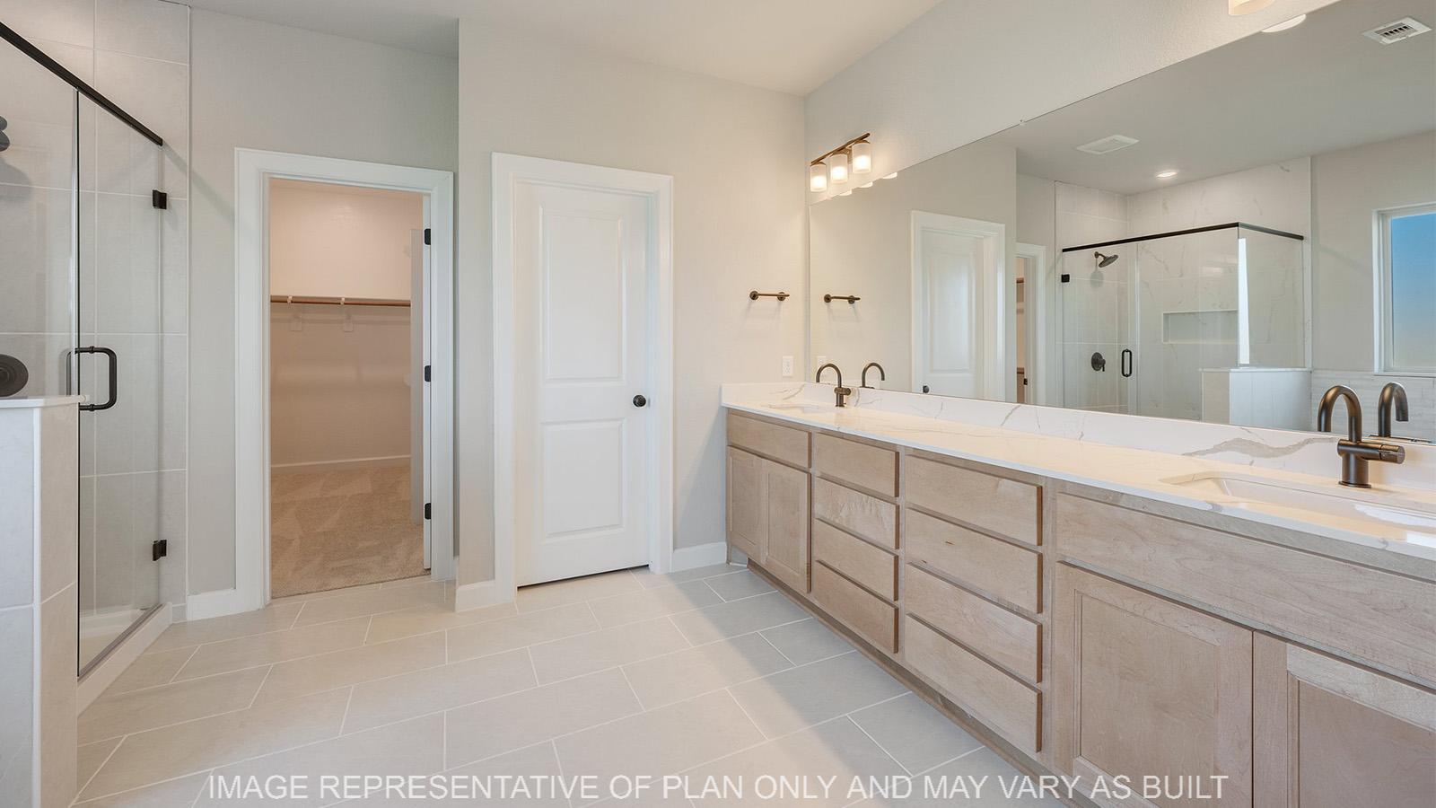Norwood primary bathroom with dual vanity, tile flooring, and maple cabinetry.