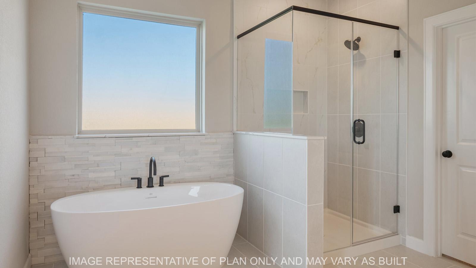 Norwood primary bathroom with separate tub and shower.