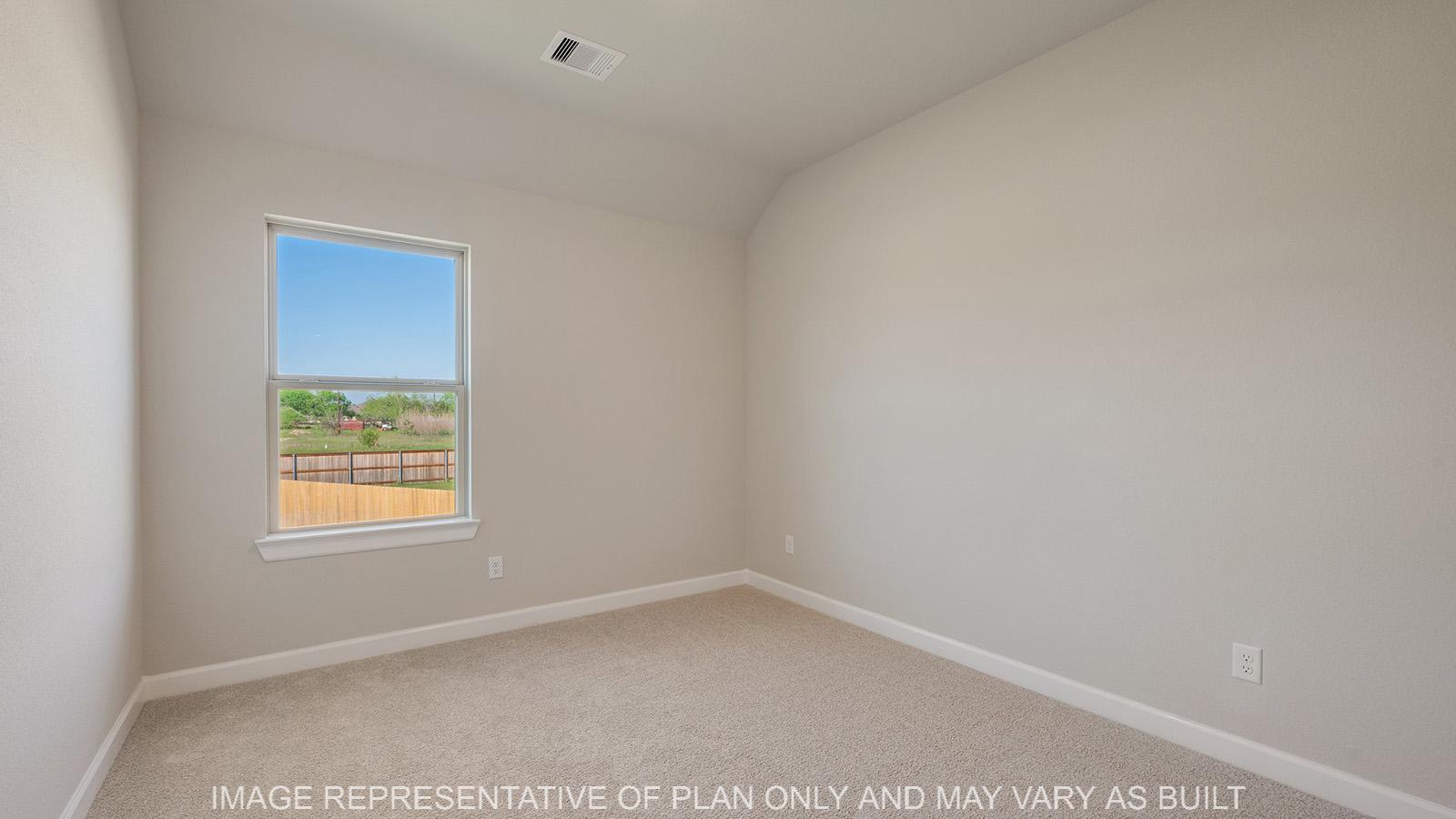 Norwood secondary bedroom with carpeted flooring and window.