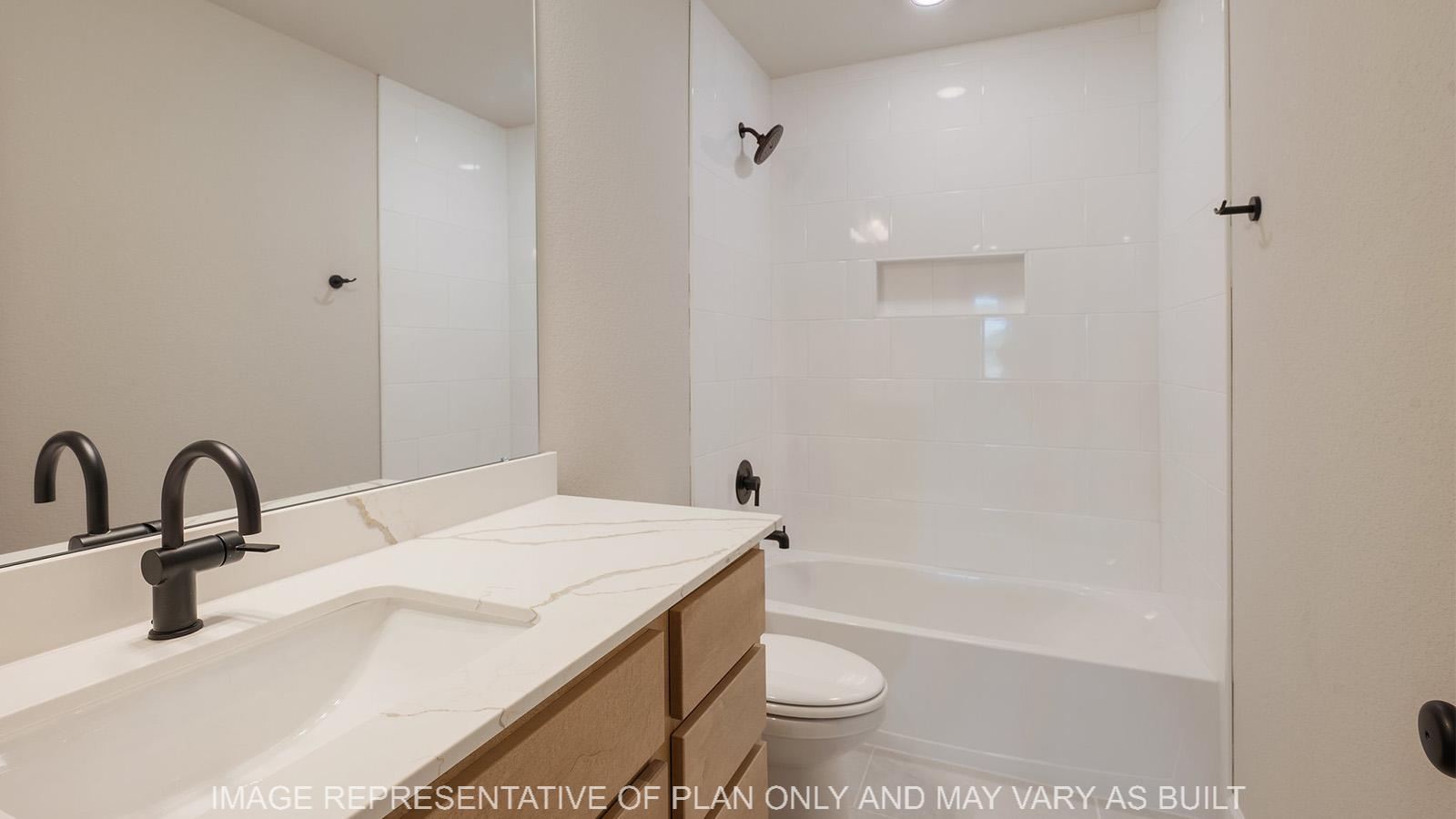 Norwood secondary bathroom with shower/tub combo, maple cabinetry, and quartz vanity.
