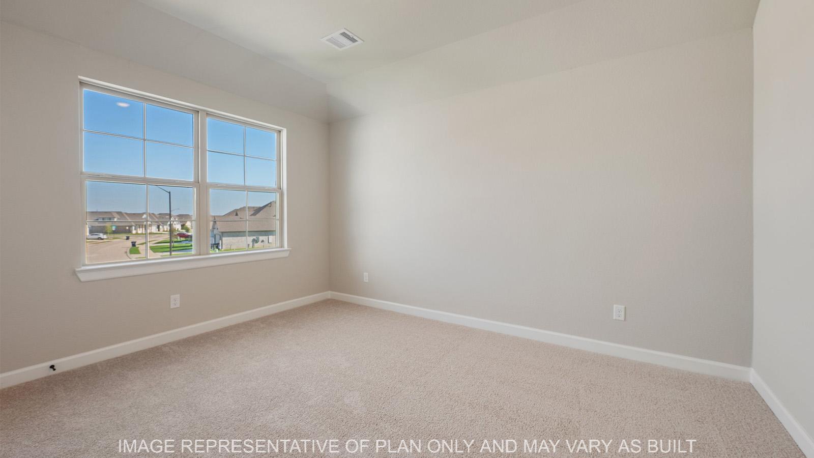 Norwood secondary bedroom with carpeted flooring and window.