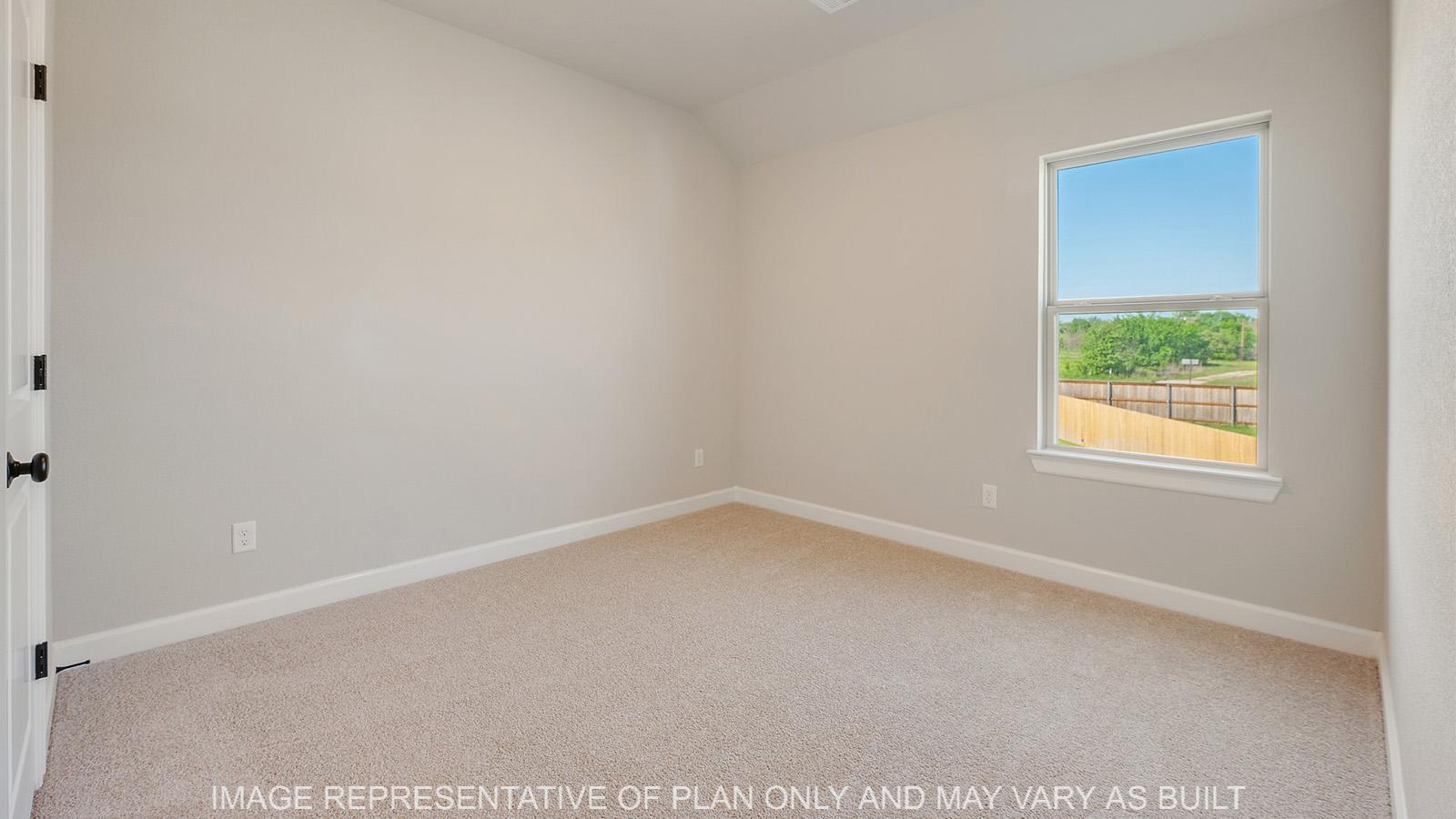 Norwood secondary bedroom with carpeted flooring and window.