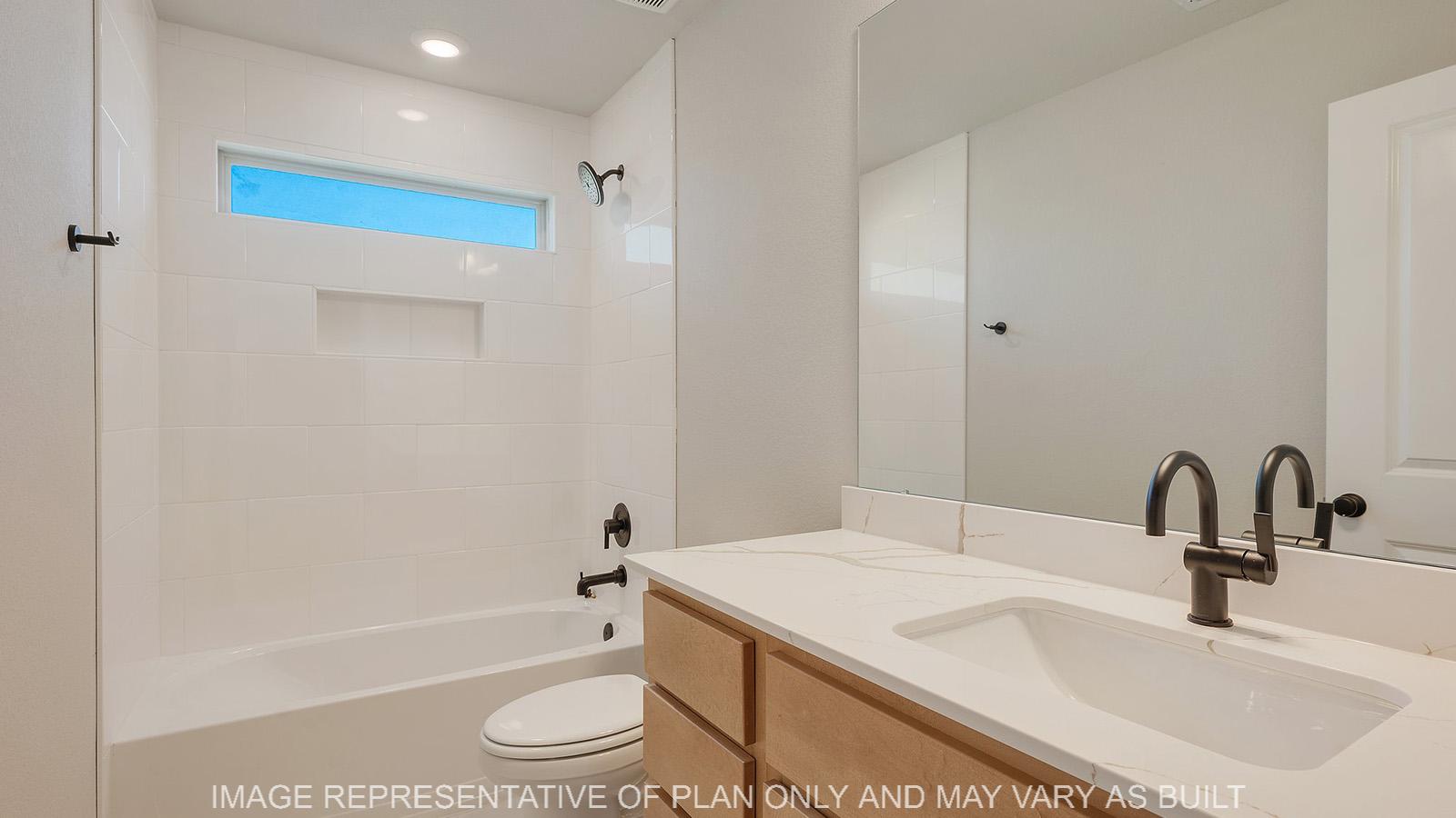 Norwood secondary bathroom with shower/tub combo, maple cabinetry, and quartz vanity.