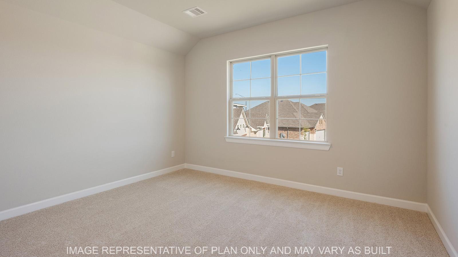 Norwood secondary bedroom with carpeted flooring and window.
