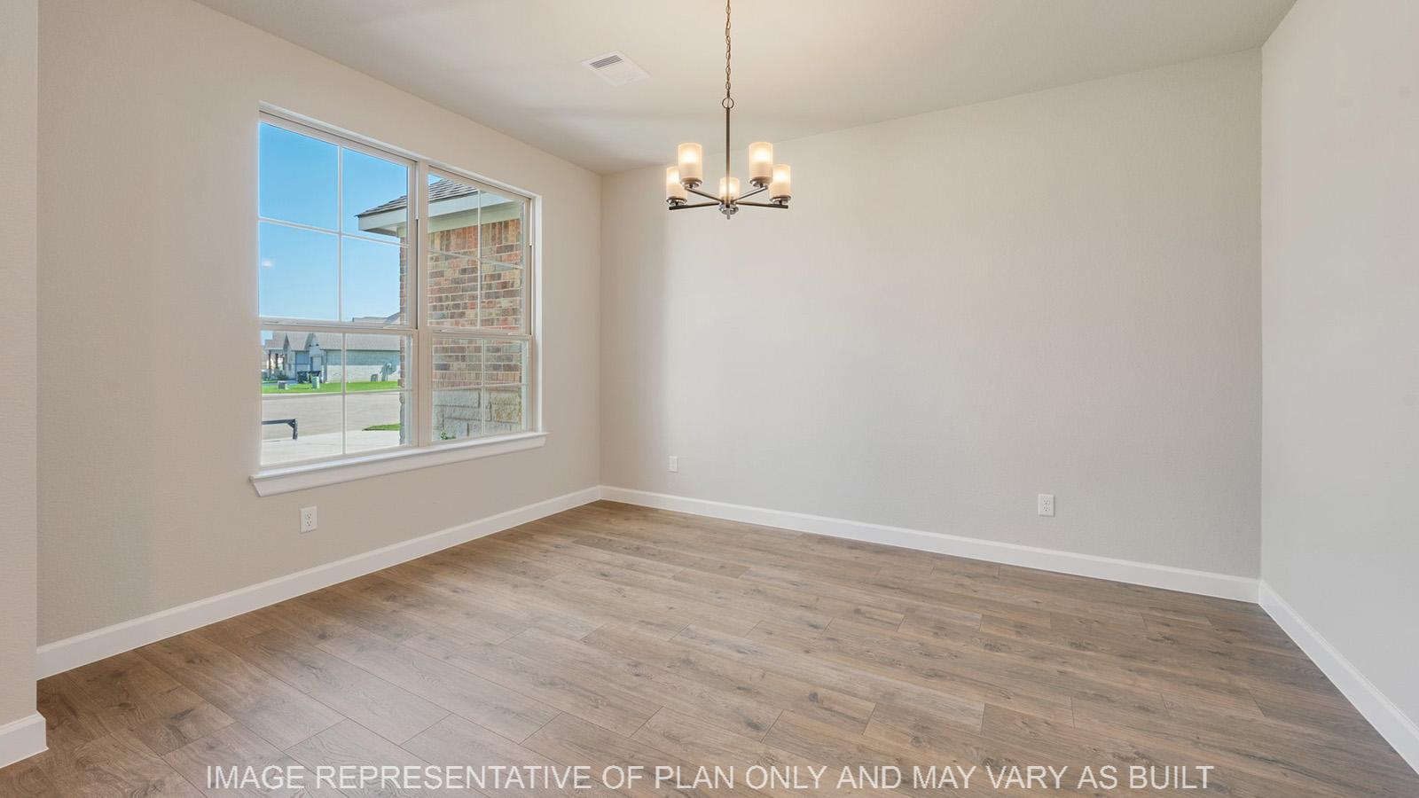 Norwood dining room with laminate flooring and windows.