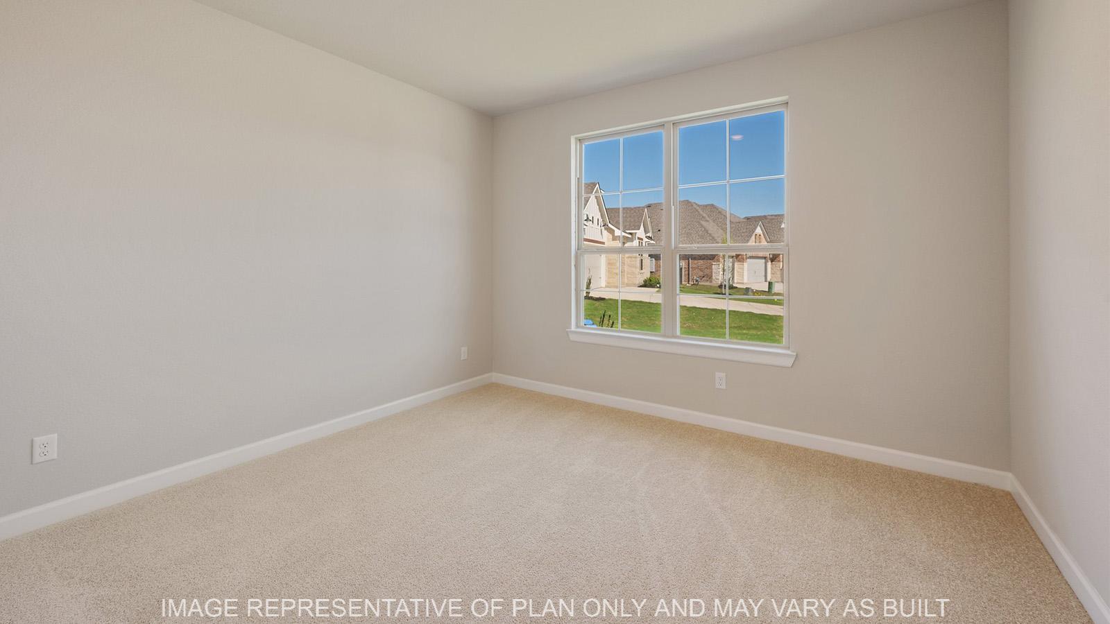 Norwood secondary bedroom with carpeted flooring and window.