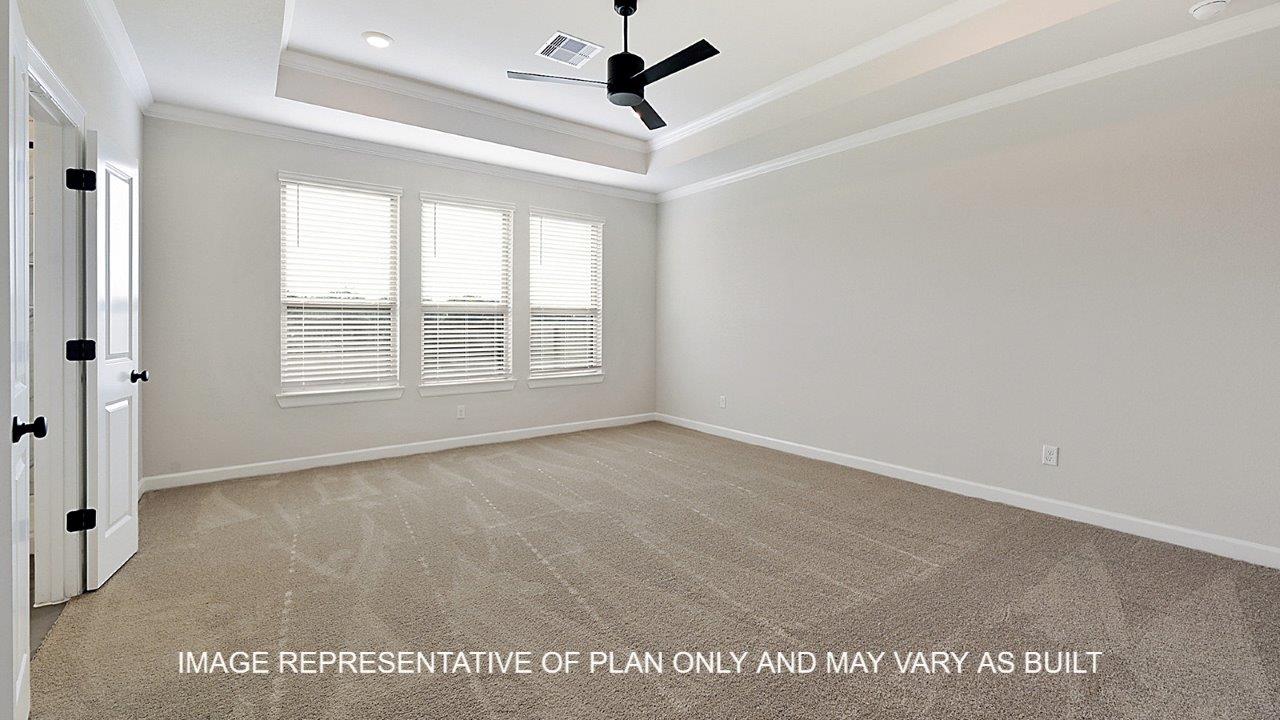Kensington primary bedroom with carpet and view to primary bathroom.