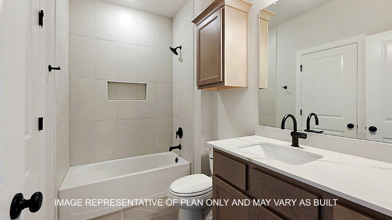 Kensington secondary bathroom with light stained cabinets, white quartz countertops and matte black fixtures.
