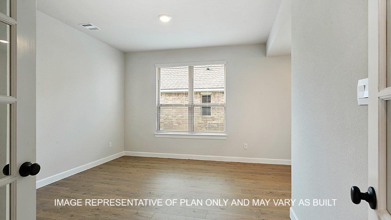 Kensington study with dark laminate wood flooring and window.