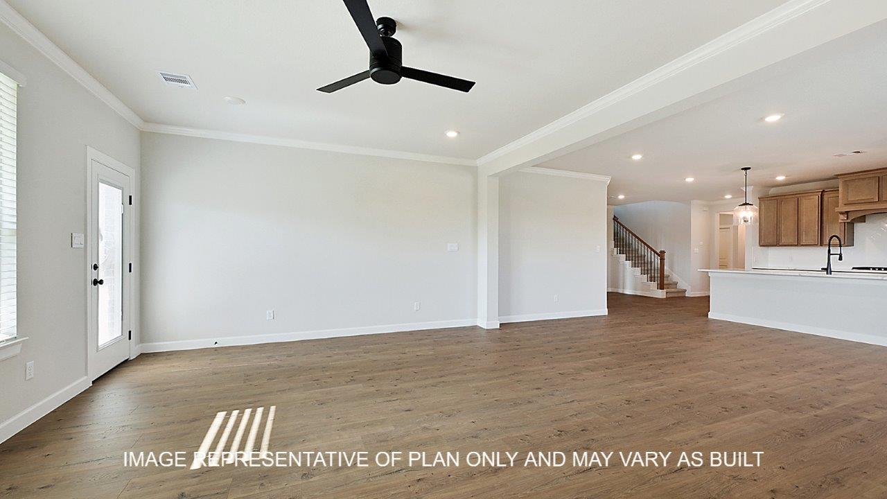 Kensington living room with laminate wood flooring and view into open concept kitchen.
