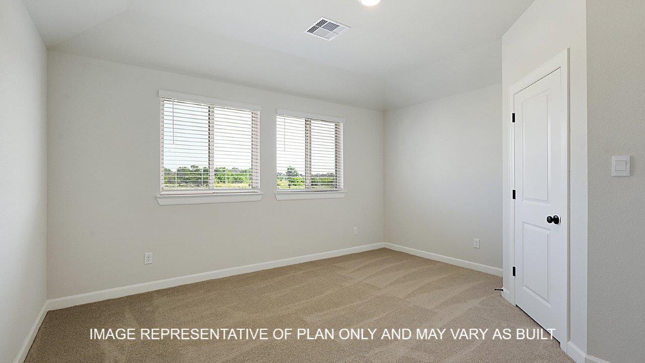 Kensington secondary bedroom with carpet and windows.