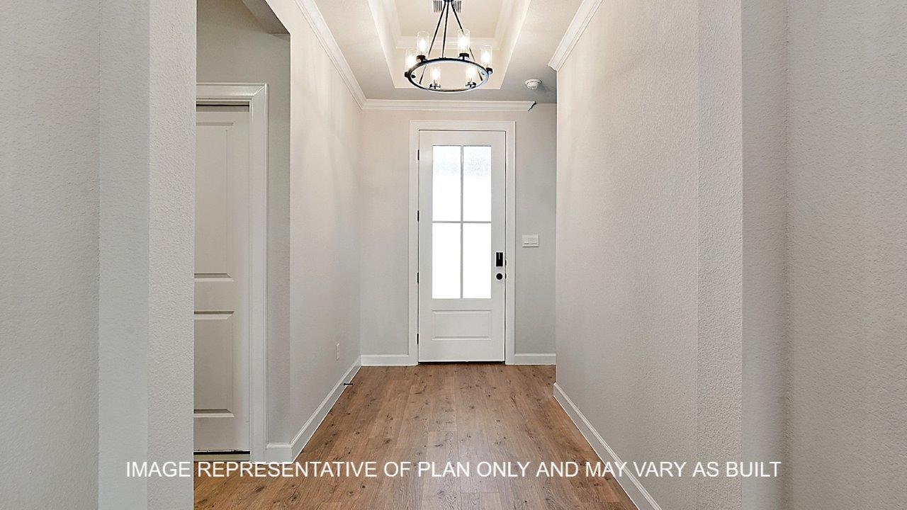 Kensington entry with dark laminate flooring and view of front door.