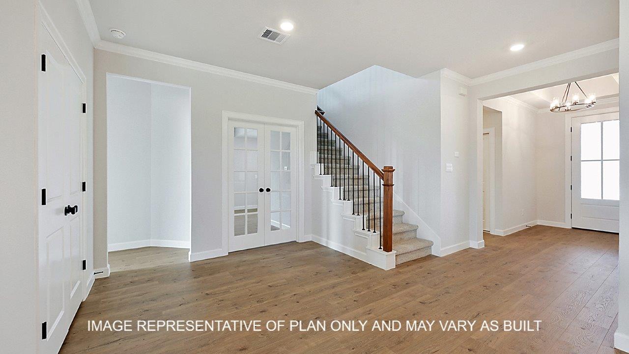 Kensington entry with dark laminate flooring and view of study and stairs.