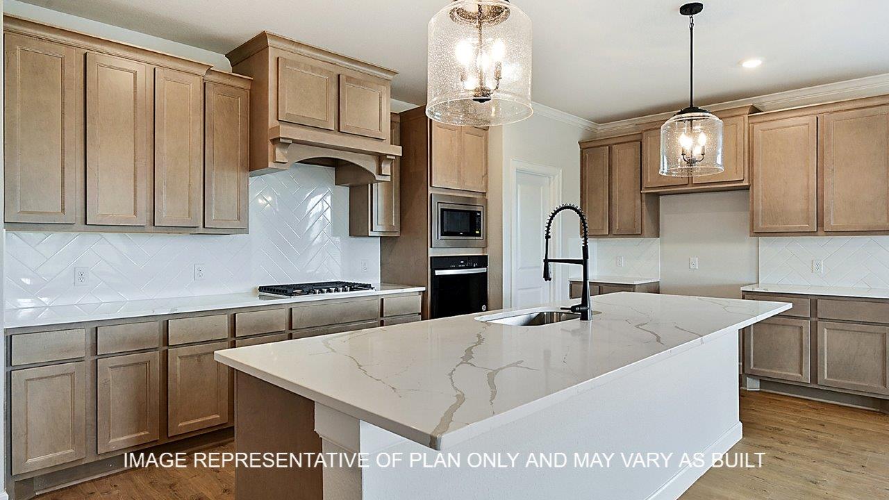 Kensington kitchen with light stained cabinets, white herringbone backsplash, quartz countertops and laminate wood flooring.