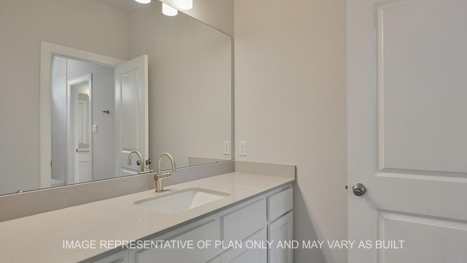 Hampton downstairs secondary bathroom with quarts countertops and white cabinetry.