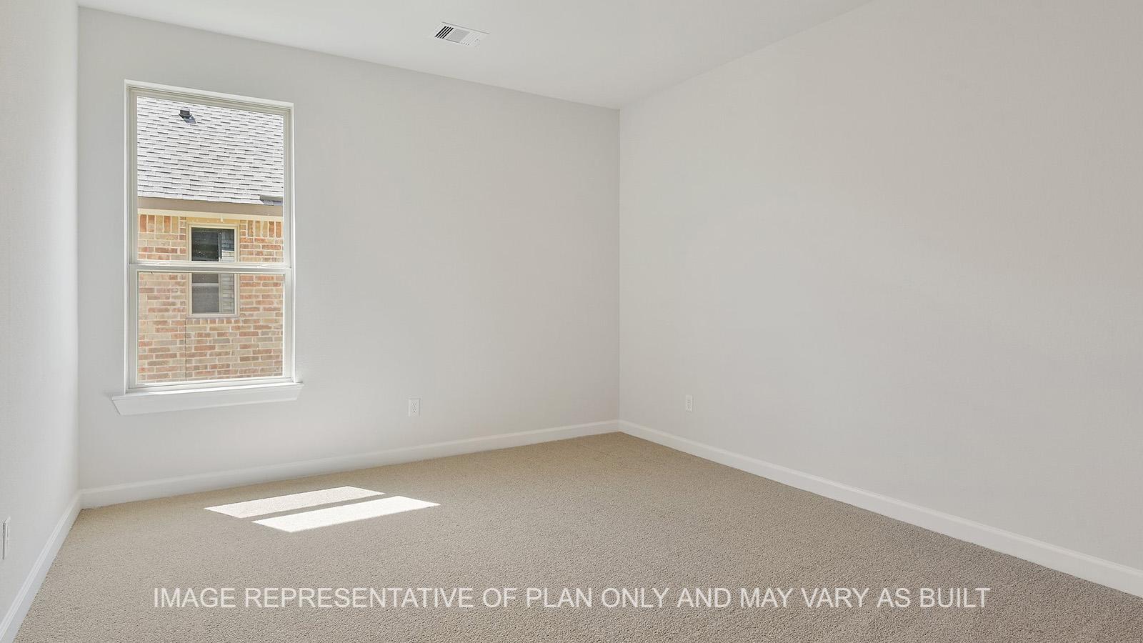 Hampton secondary bedroom with window and carpeted flooring.