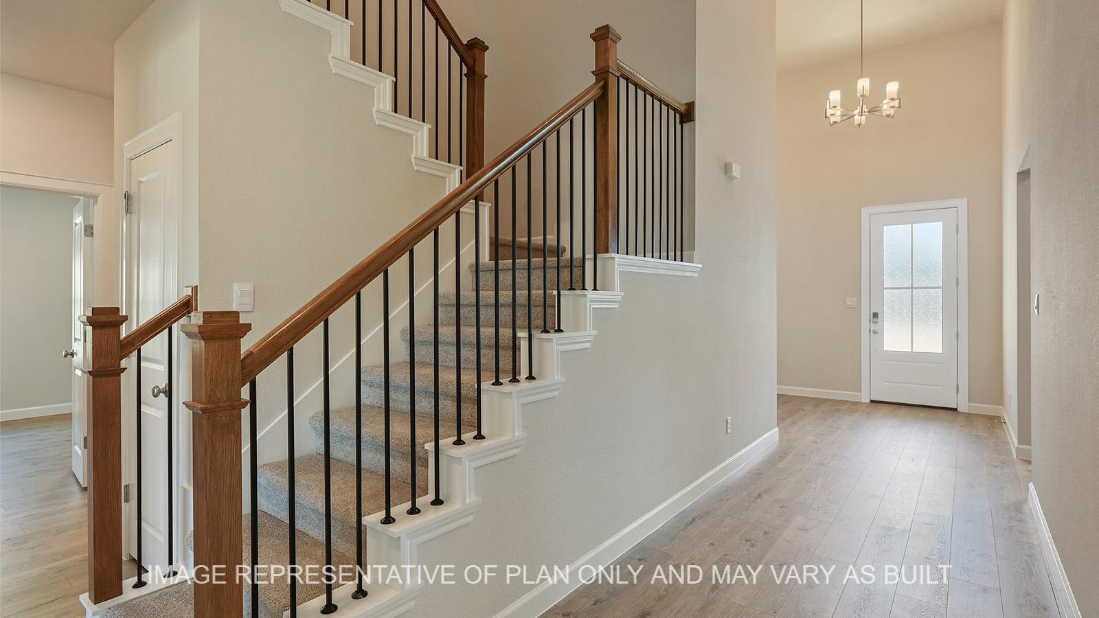 Hampton entry with laminated flooring and staircase.