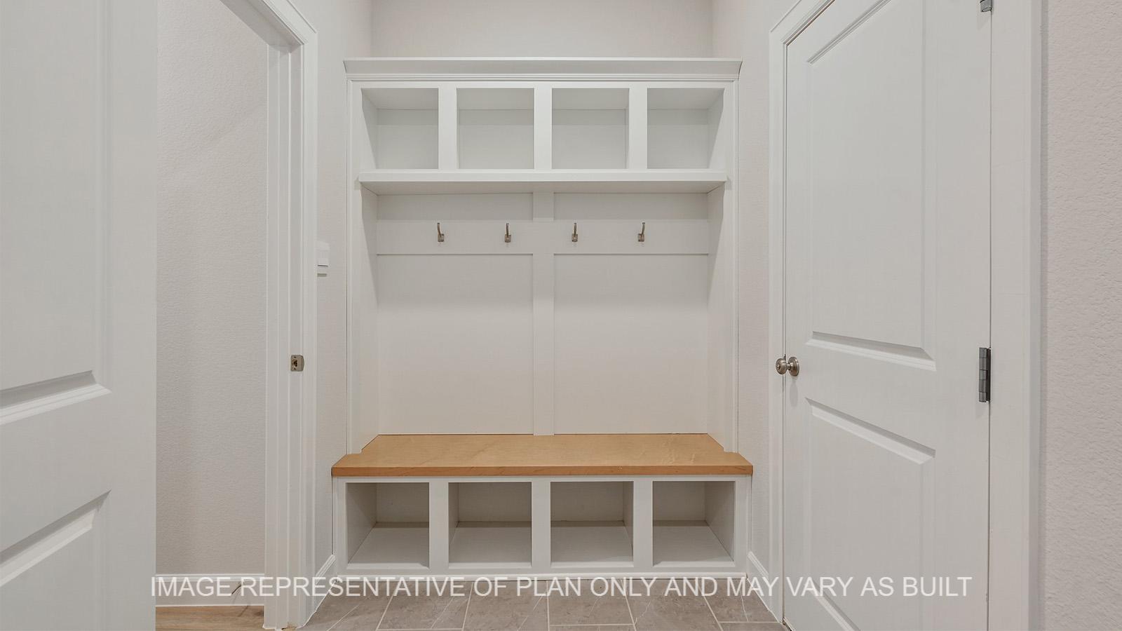 Hampton mud room with bench, cubbies, and hooks.