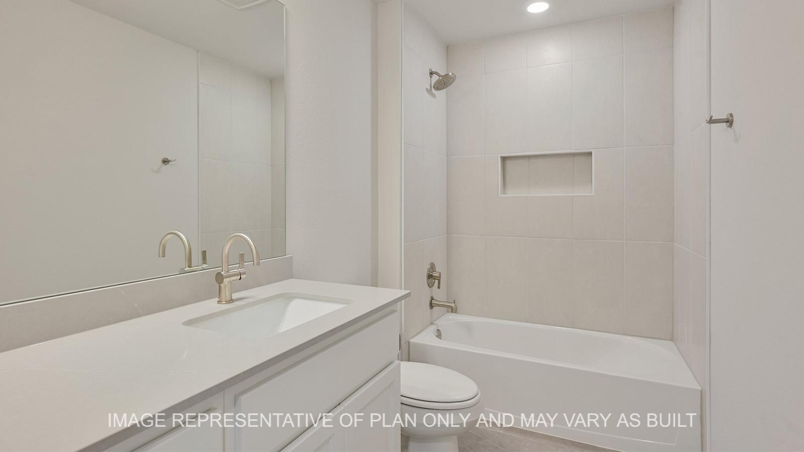 Hampton secondary bathroom with quarts countertops and tile surround shower.