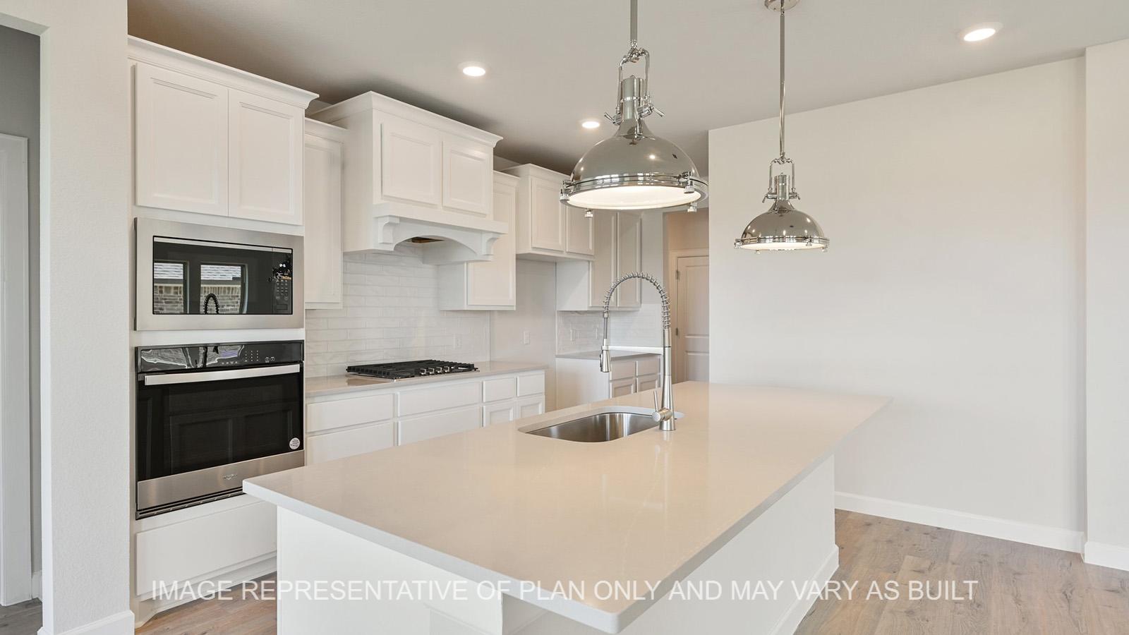 Hampton kitchen with stainless-steel appliances and white tile backsplash.