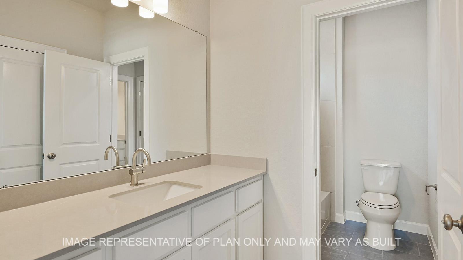 Hampton secondary jack and jill bathroom with quarts countertops and tile flooring.