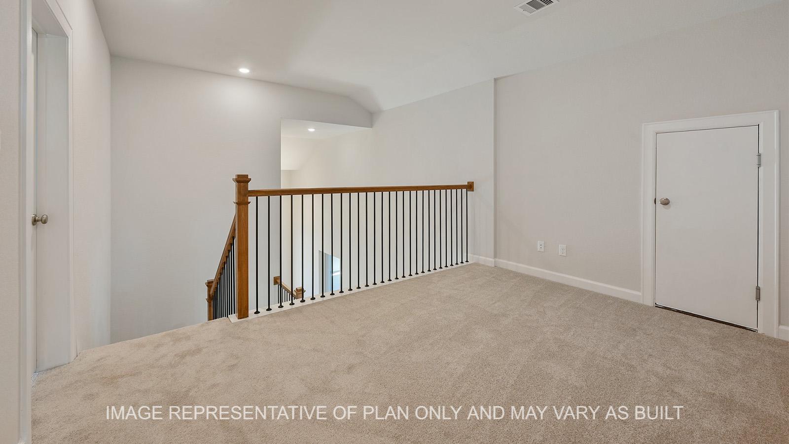 Hampton loft with carpeted flooring, attic access and view to downstairs.