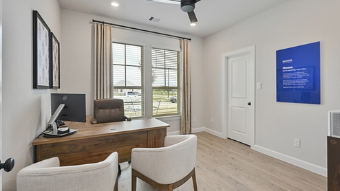 Secondary bedroom with large window and light colored carpet.