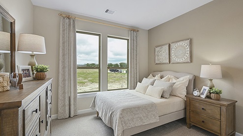 Secondary bedroom with natural light, and light colored carpet.