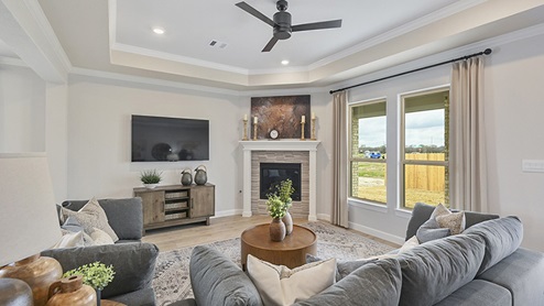 Spacious living room with stone detail on corner fireplace.