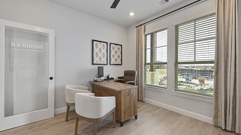 Secondary bedroom with large window and light colored carpet.