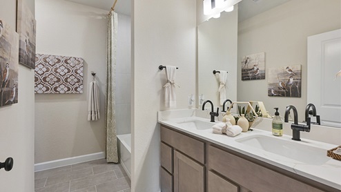 Secondary bathroom with ceramic tile surround on shower.