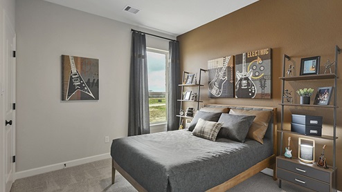 Secondary bedroom with accent paint on wall.