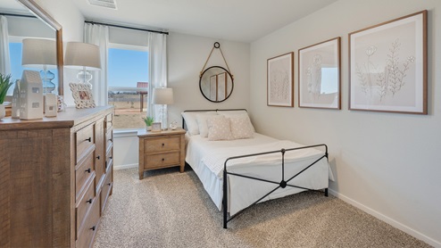 Cornerstone Caroline secondary bedroom with carpet and window, with neutral decor.