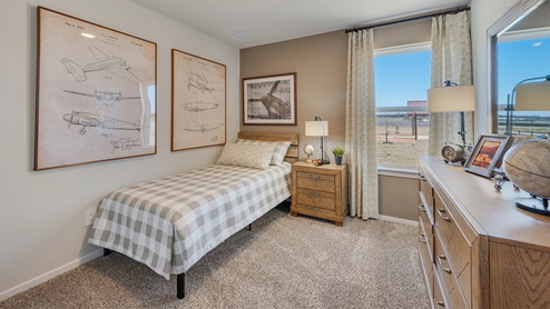 Cornerstone Caroline secondary bedroom with carpet and window and airplane themed decor.