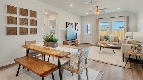 Cornerstone Caroline Open concept dining table with view to living area.