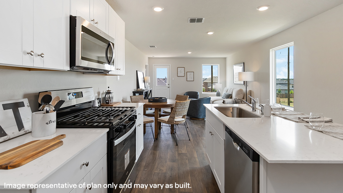 Atlanta kitchen with white cabinets and view of dining room and living room.