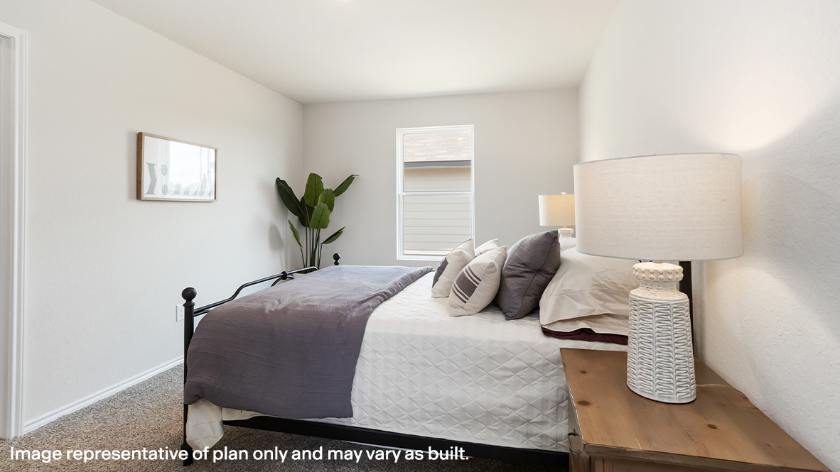 Atlanta primary bedroom with carpet flooring and window for natural lighting.