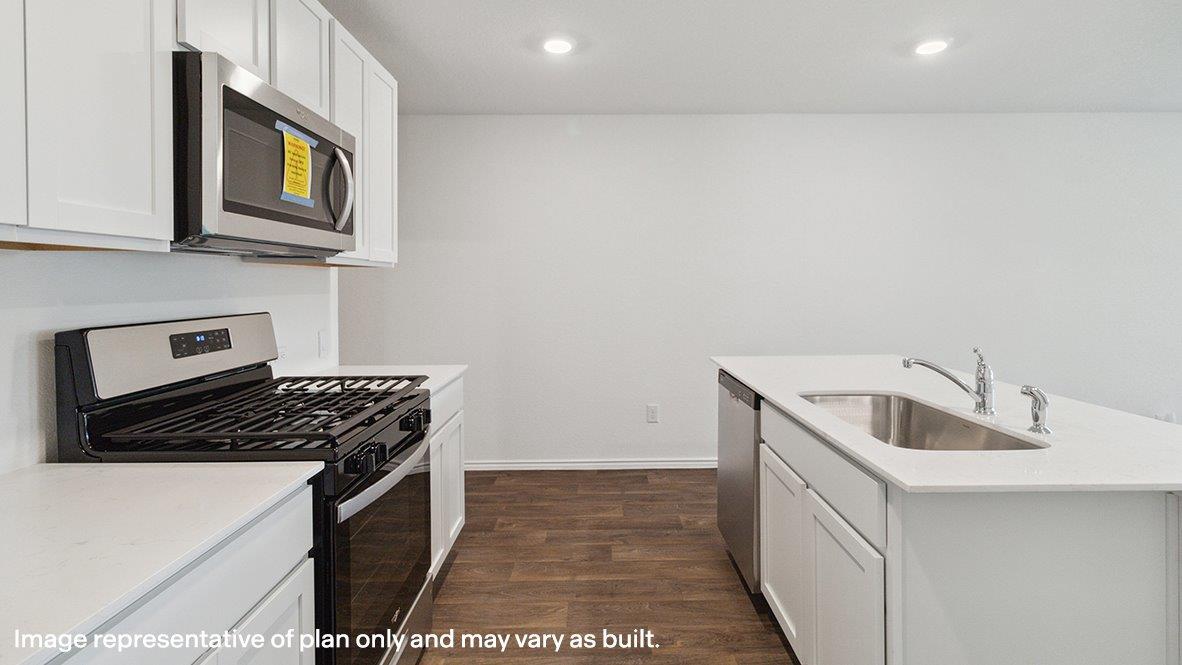 Caprock kitchen with white cabinets and granite countertops.