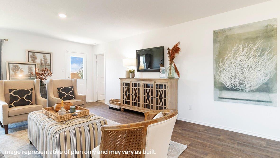 Estero living room with view of primary bedroom and back yard.