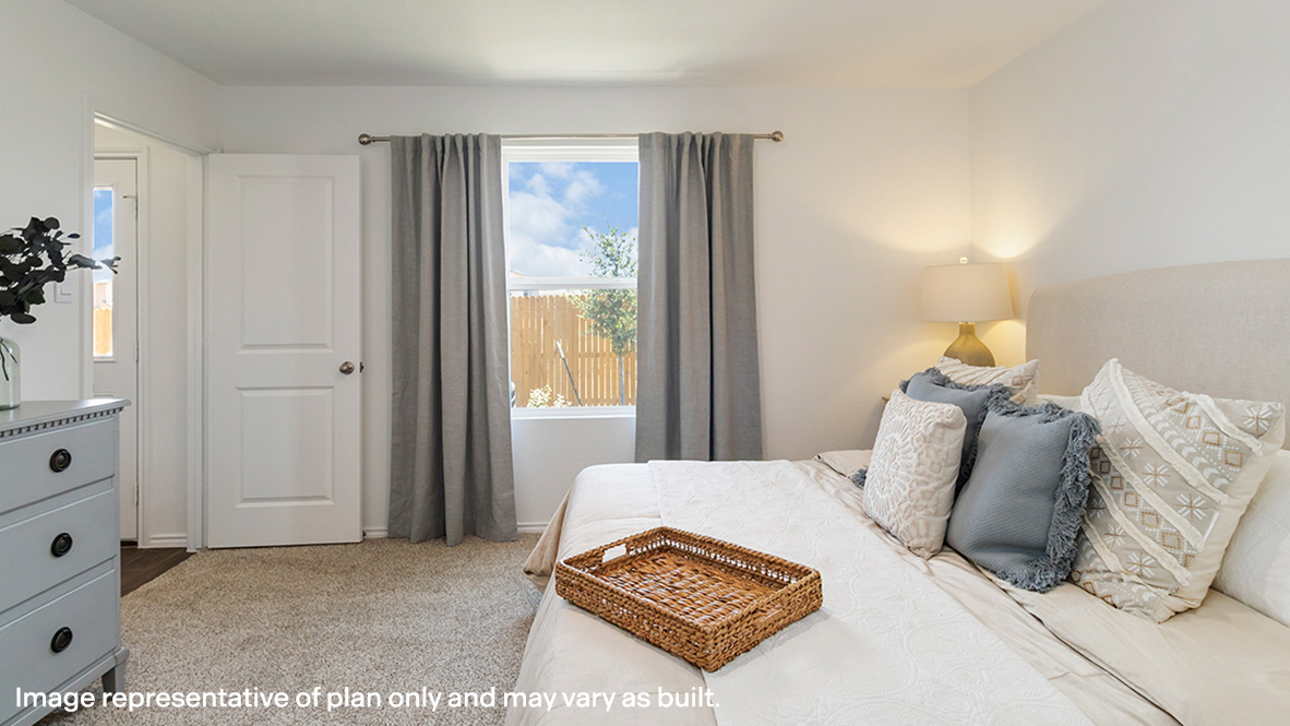 Estero primary bedroom with carpeted flooring and window for lighting.