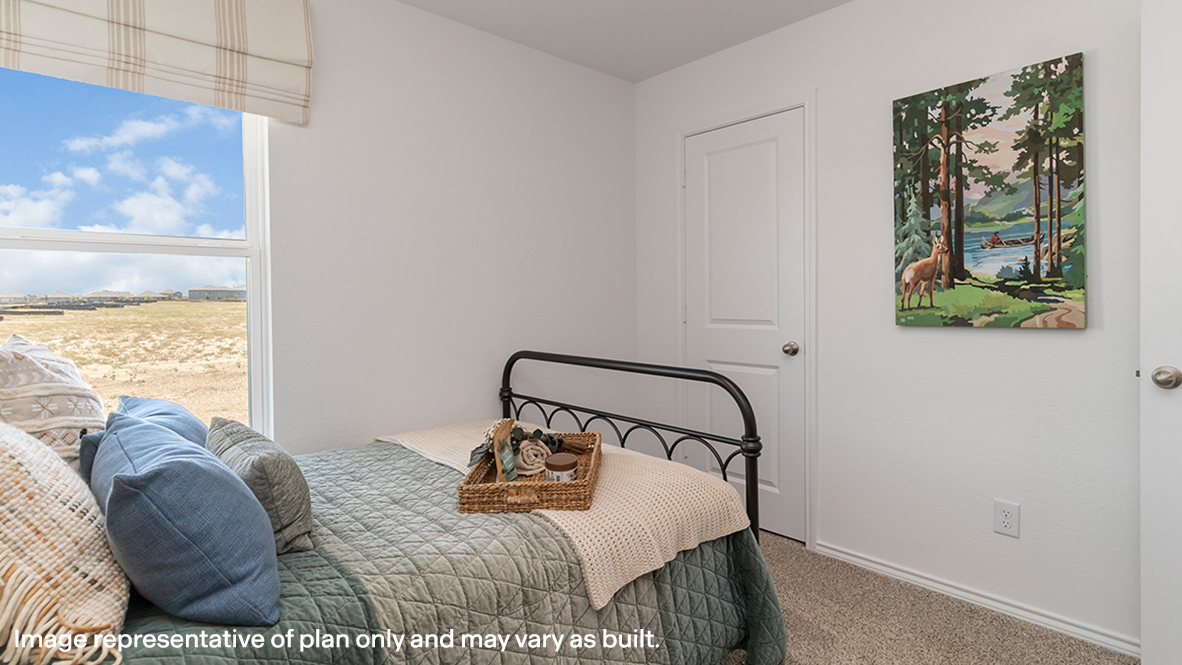 Estero secondary bedroom with carpeted flooring and closet door.