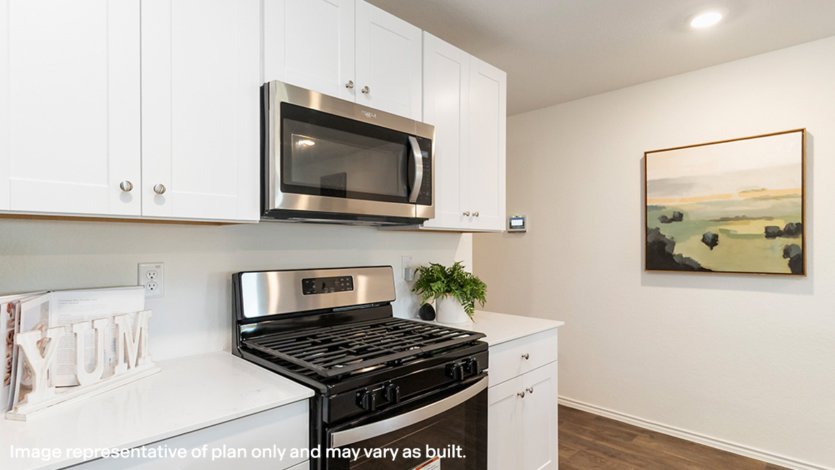 Estero kitchen white cabinets and granite countertops.