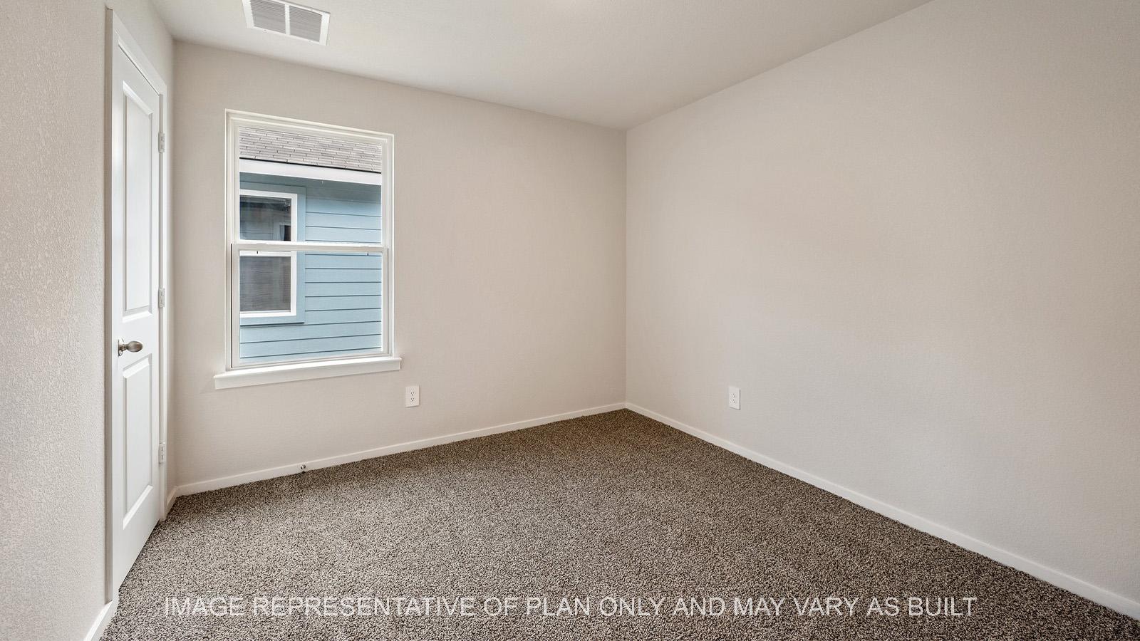 Amber secondary bedroom with window, carpeted flooring, and closet.