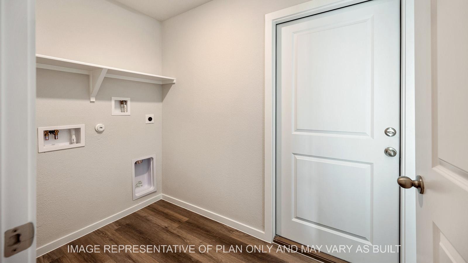 Amber utility room with vinyl plank flooring.
