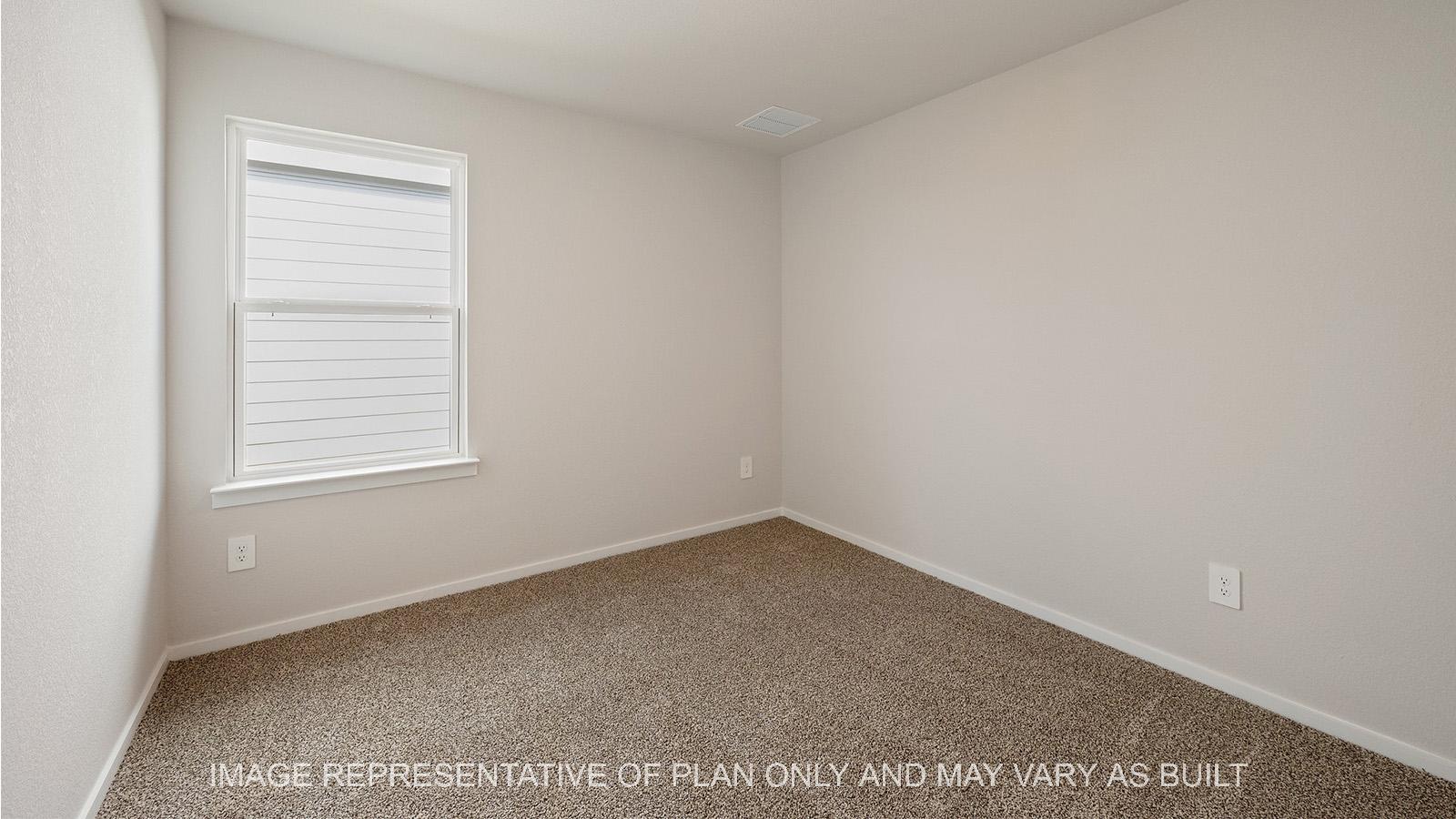 Caroline secondary bedroom with carpeted flooring and window.