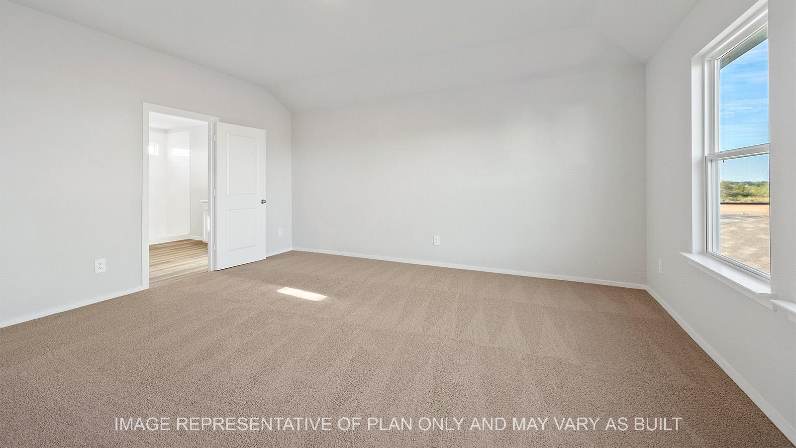 Emma primary bedroom ith carpeted flooring and bathroom access.