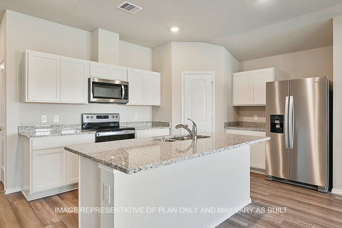 Texas Cali kitchen with white cabinets, granite countertops and vinyl plank flooring.