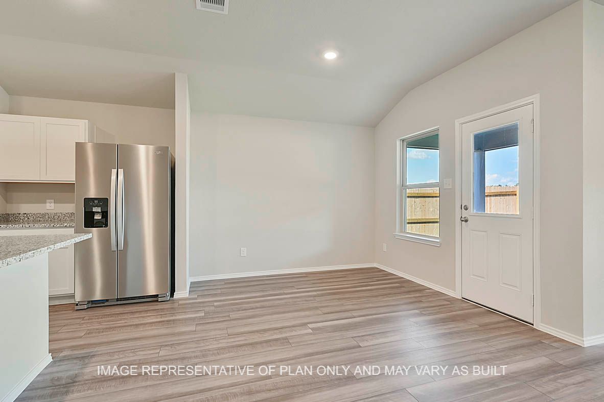 Texas Cali dining room with windows and vinyl plank flooring.