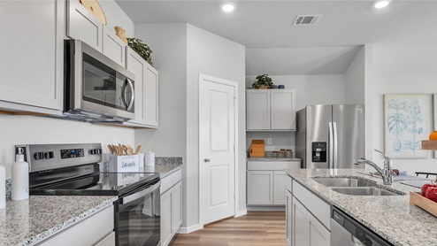 Cornerstone Kitchen with granite countertops and stainless-steel appliances.